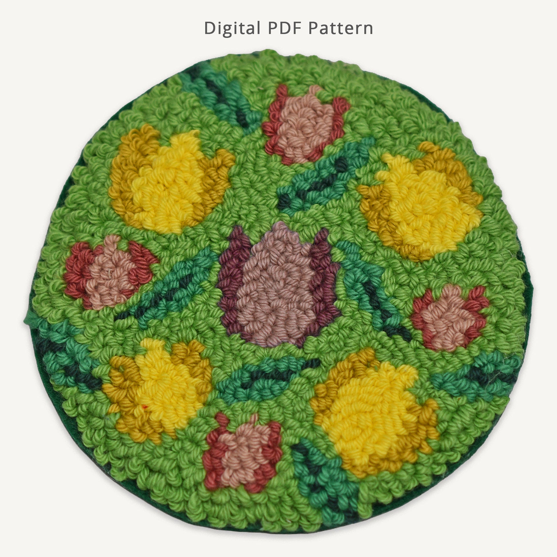 Floral tulip punch needle coaster digital PDF pattern featuring yellow and pink tulips on a green background, handmade spring-inspired punch needle design for DIY crafting.