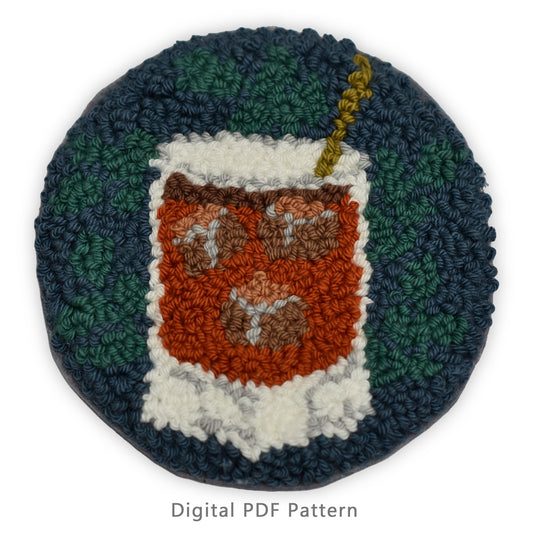 Round punch needle coaster design of a whiskey cocktail with ice cubes on a dark teal background, digital PDF pattern.