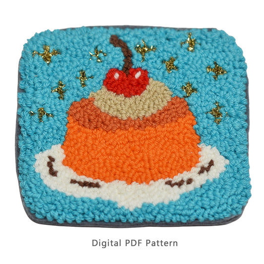 Punch needle digital PDF pattern featuring orange jelly dessert on white cream with whipped topping and cherry on a turquoise background.