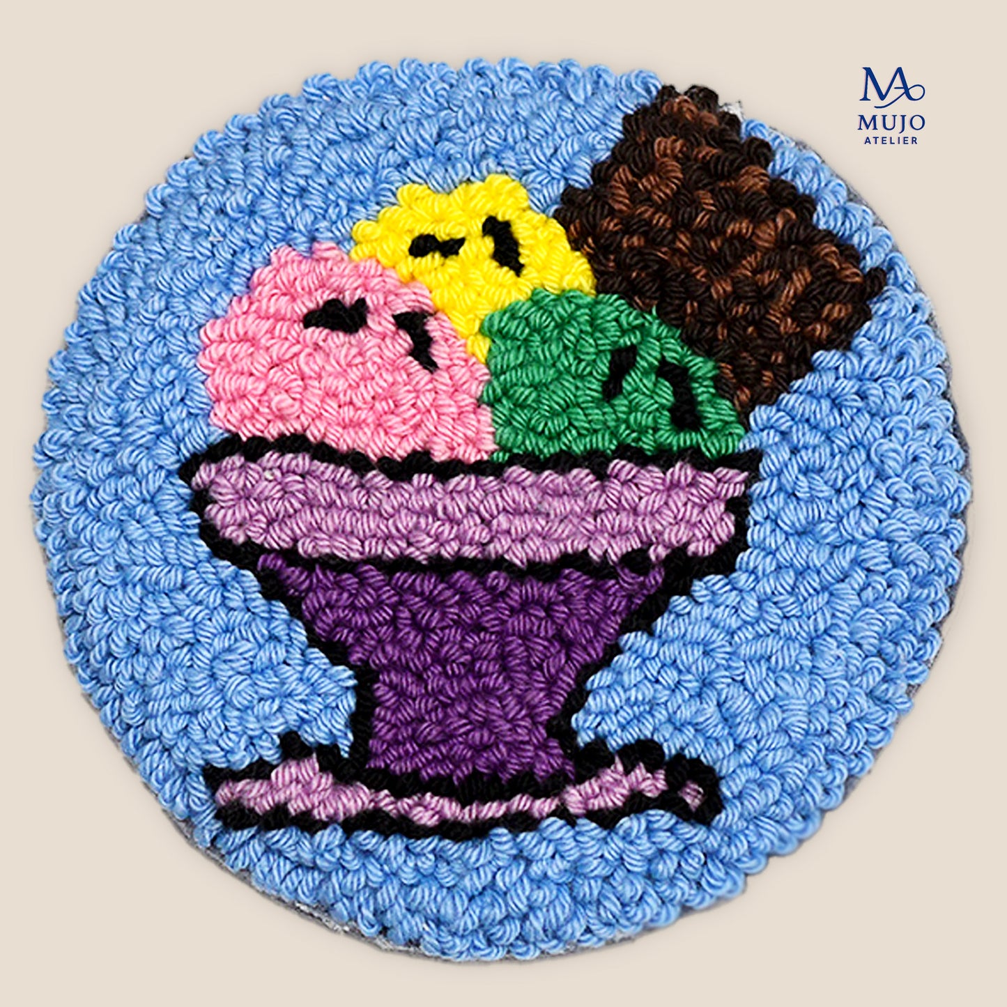 Punch needle ice cream sundae coaster pattern featuring colorful scoops of pink, yellow, green, purple, and chocolate ice cream in a purple dessert bowl on a blue background. Digital PDF embroidery pattern by Mujo Atelier.