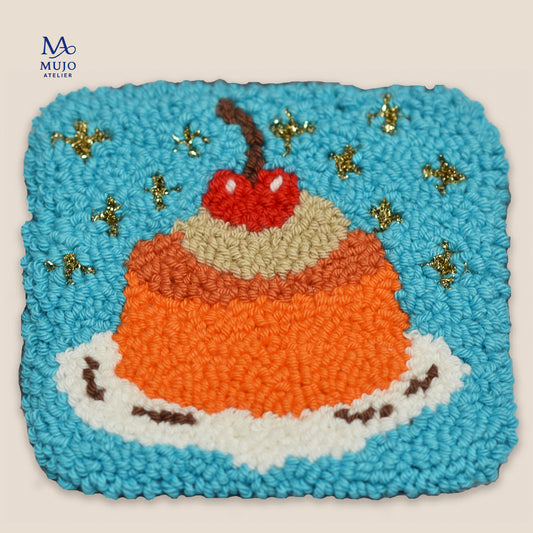 Punch needle jelly dessert coaster pattern with whipped cream, cherry and sparkling stars on a blue background. Digital PDF embroidery pattern by Mujo Atelier.