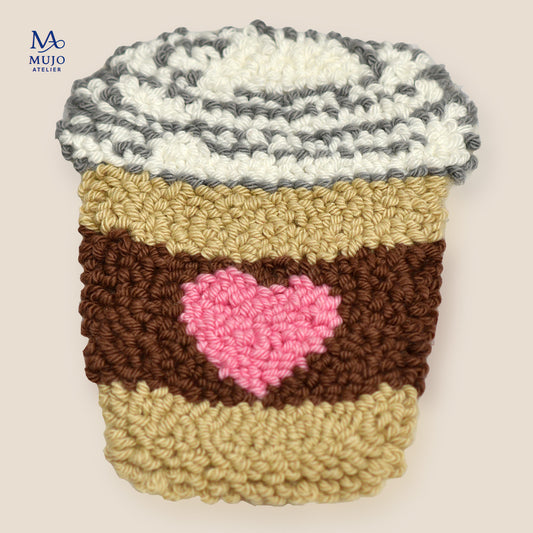 Punch needle coffee cup coaster pattern with pink heart sleeve, digital PDF embroidery design for beginners on a neutral background.