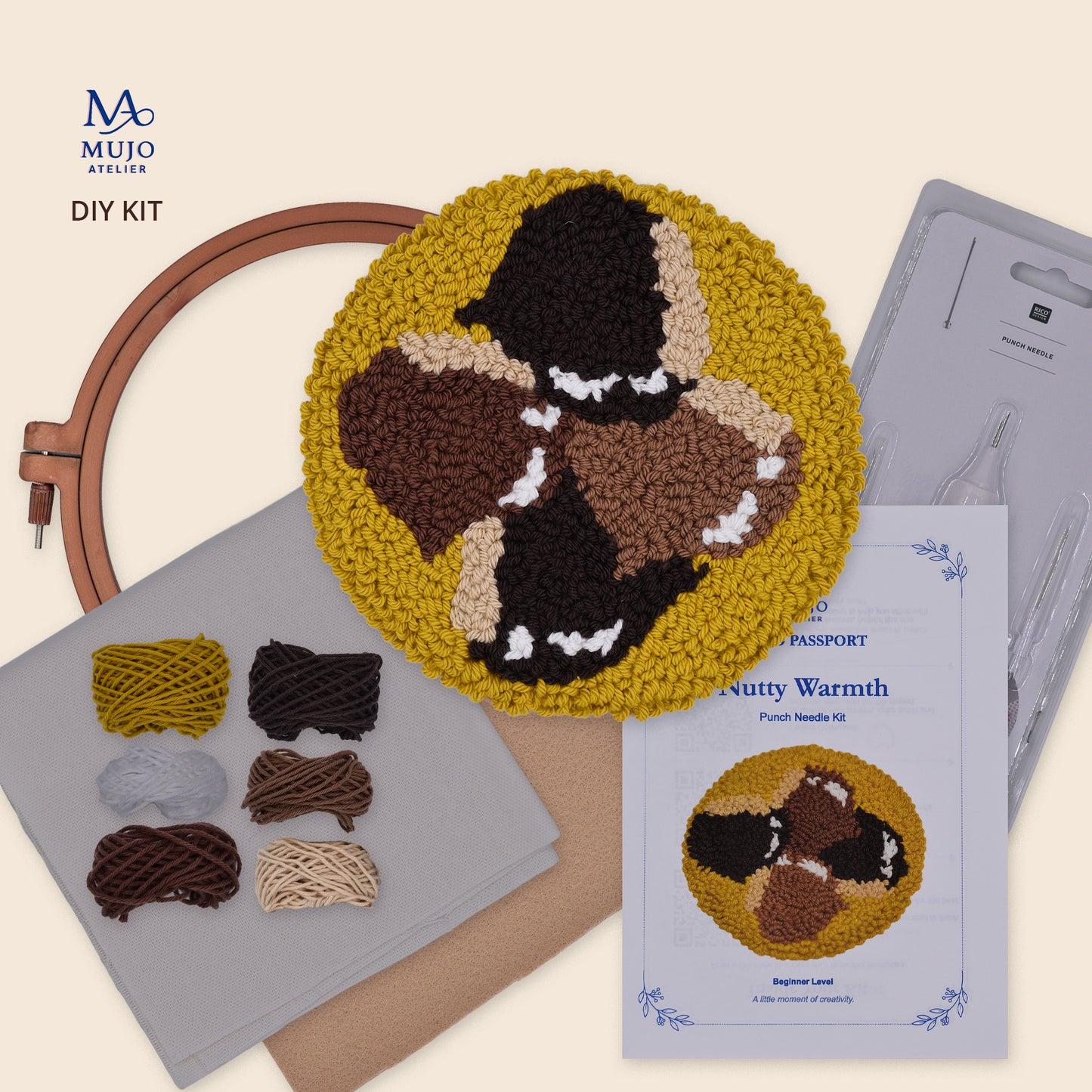Nutty Warmth chestnut punch needle DIY kit with finished autumn coaster, embroidery hoop, punch needle, cotton yarn, fabric, felt and Mujo Passport.