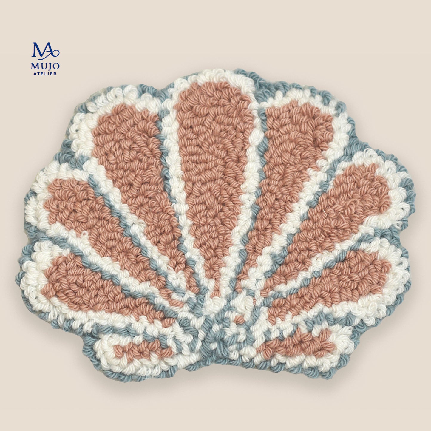 Pastel seashell punch needle coaster pattern in blush pink, white, and soft blue on a neutral beige background with Mujo Atelier branding. Digital PDF embroidery pattern for DIY punch needle craft.