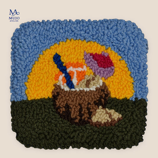 Punch needle pattern featuring a coconut cocktail in a coconut shell with blue straw, orange slice and pink-purple umbrella, set against a bright sunset.