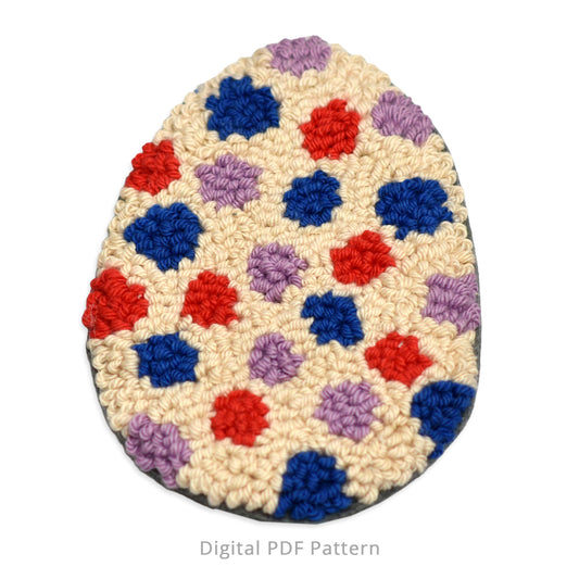 Punch needle Easter egg coaster with colorful polka dots in red, blue, and lavender on a cream background, shown as a finished textured coaster for a digital PDF pattern.