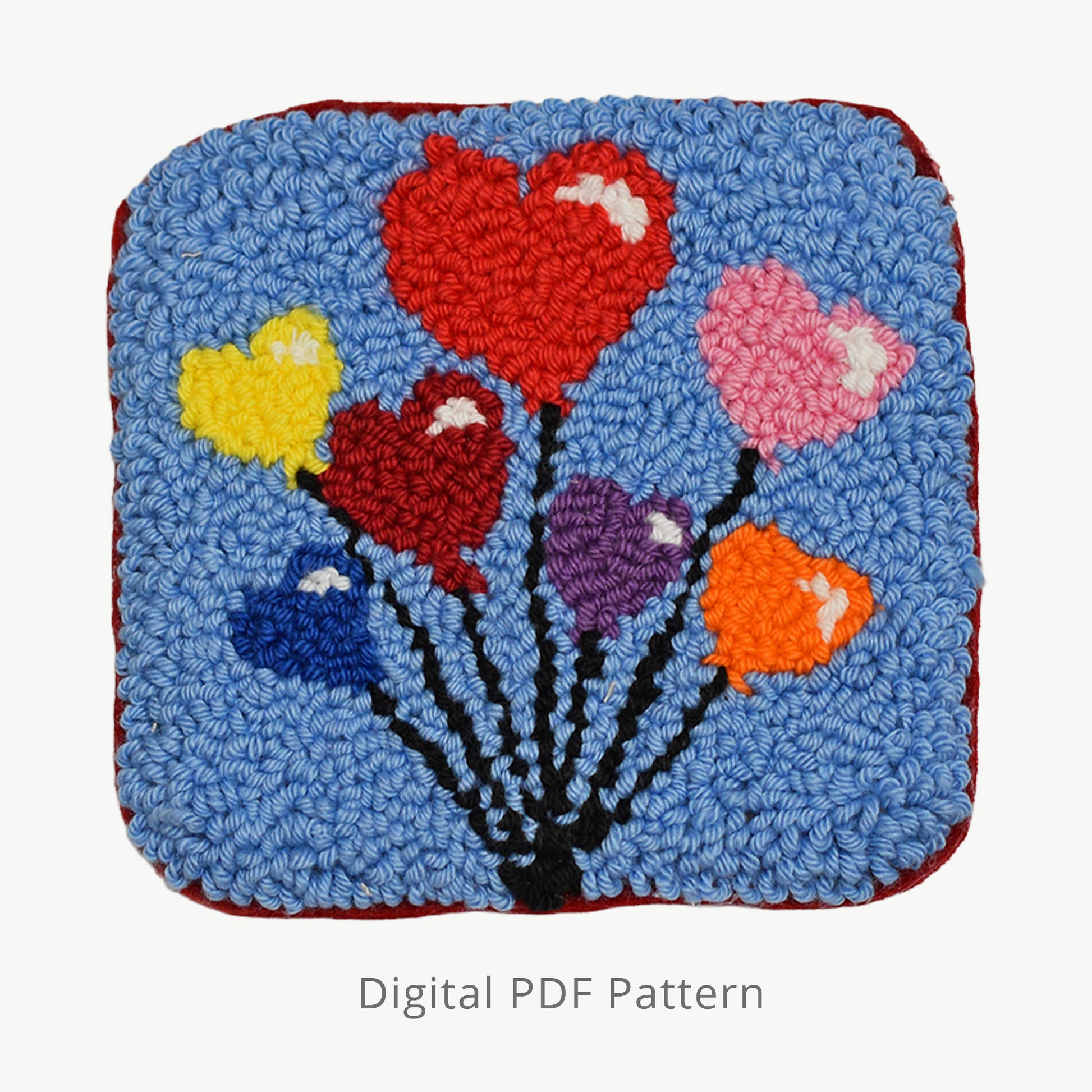 Punch needle heart balloon design on a blue background, shown as a digital PDF pattern with colorful floating heart motifs and visible yarn texture