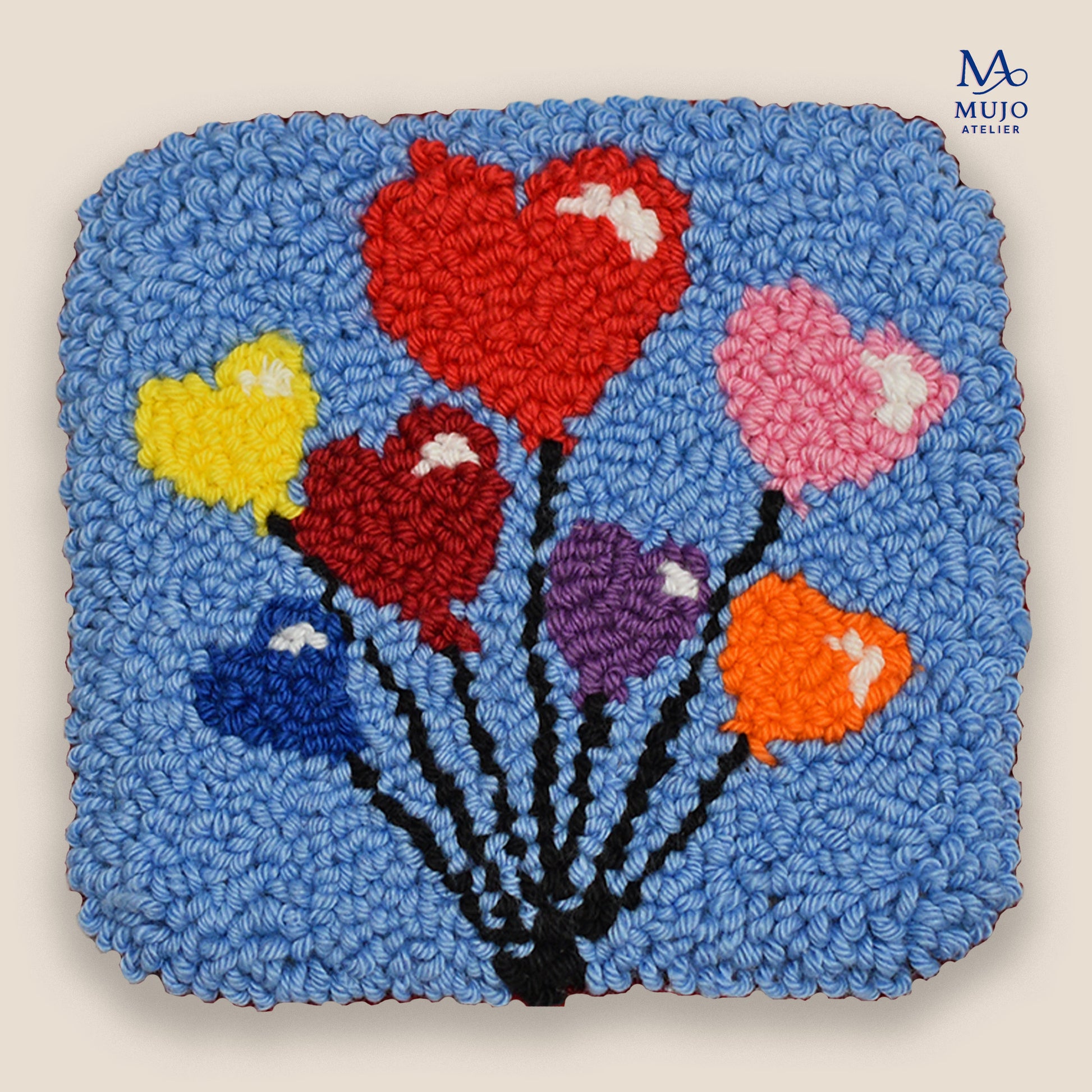 Punch needle heart balloon coaster pattern PDF with colorful heart balloons on a blue background, beginner-friendly digital embroidery pattern by Mujo Atelier.
