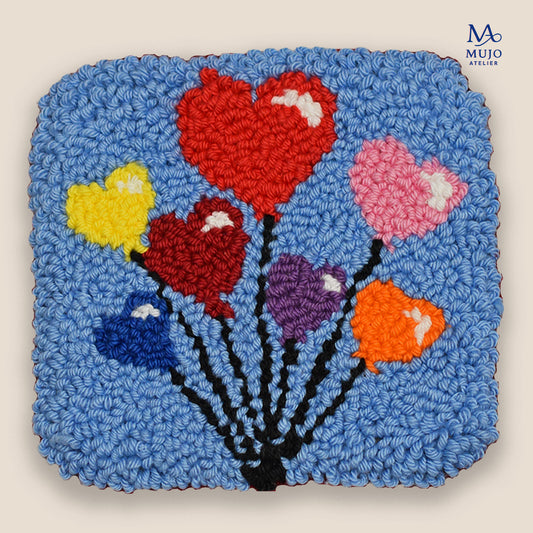 Punch needle heart balloon coaster pattern PDF with colorful heart balloons on a blue background, beginner-friendly digital embroidery pattern by Mujo Atelier.